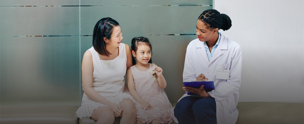 A doctor speaks with a mother and child